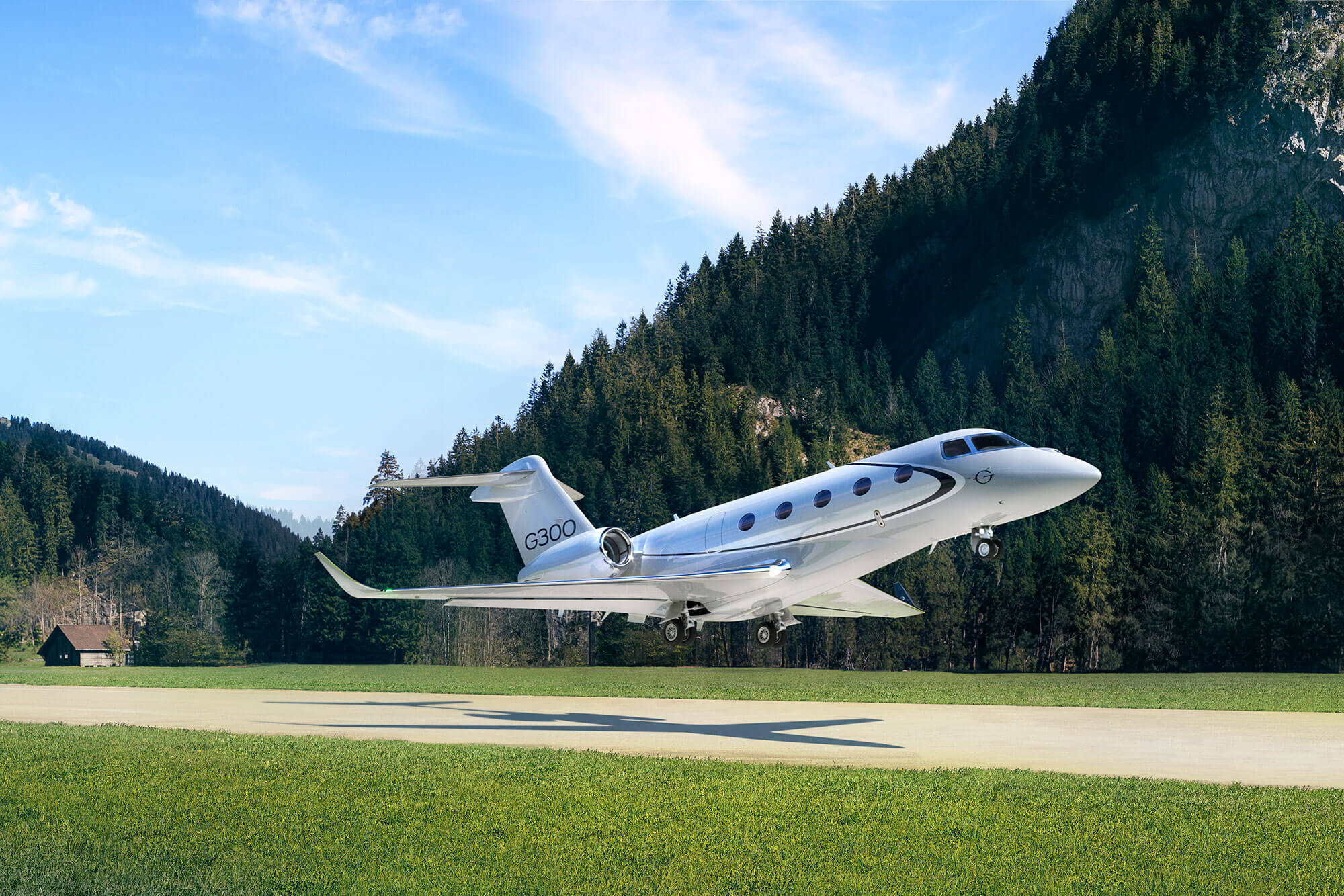 A Gulfstream G300 lifts off a short runway in beautiful, mountainous terrain.