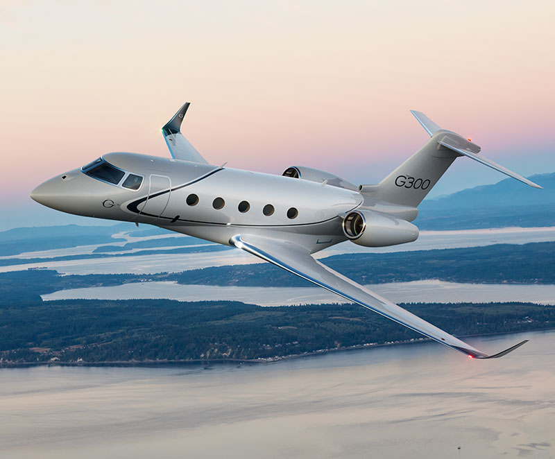 G300 flying over a coastal area of bays and inlets between tree-covered islands.