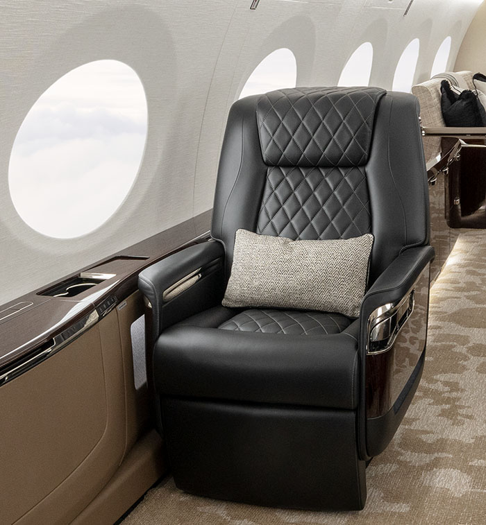 A Gulfstream G800 cabin interior with a plush chair in elegantly stiched black leather.